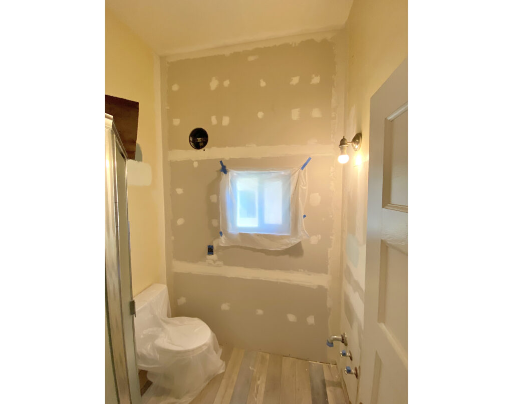 A wall with drywall being installed