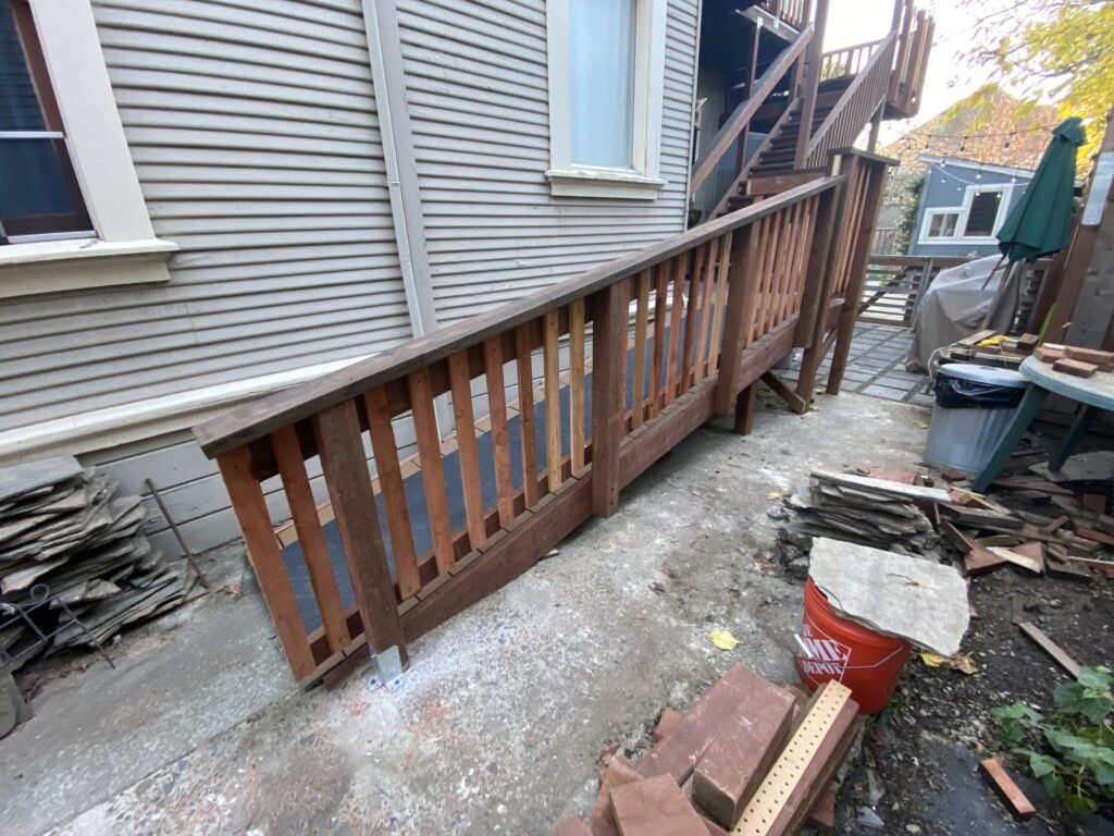 A ramp for dogs (and people) leading from a driveway to a porch