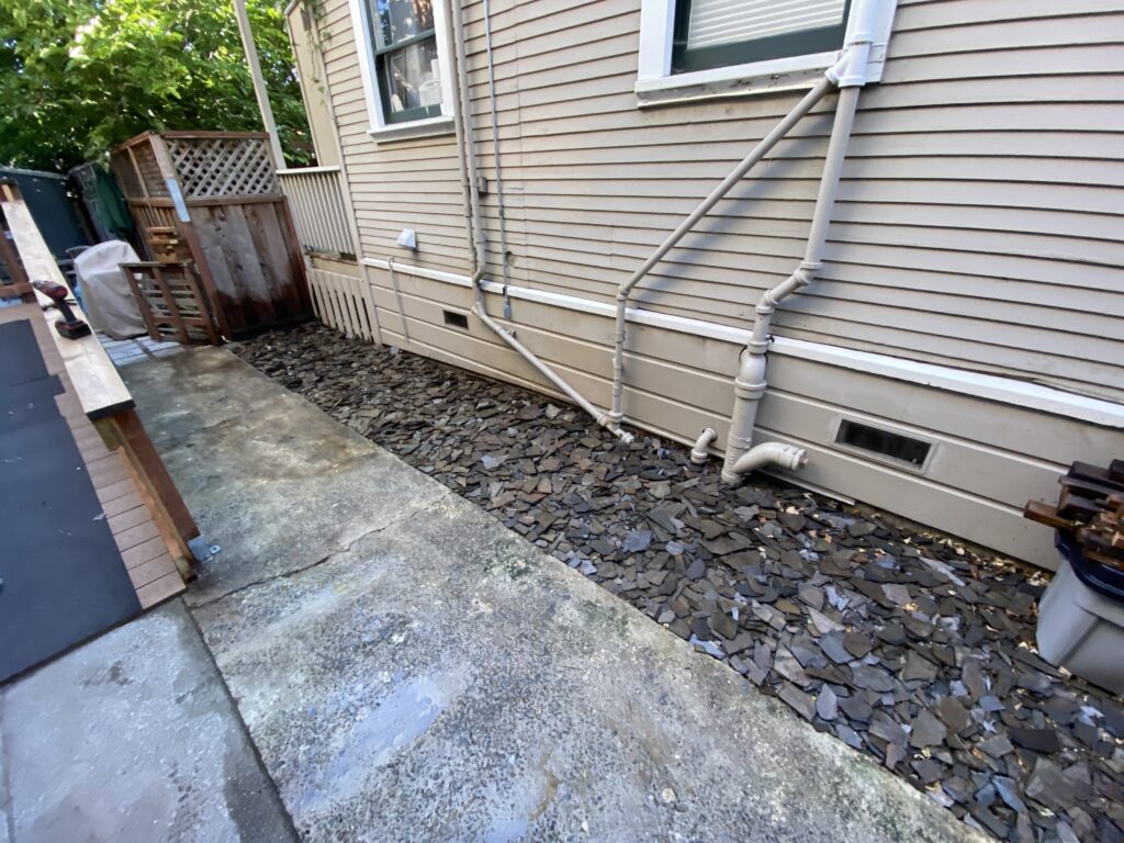 A crushed rock area next to a driveway