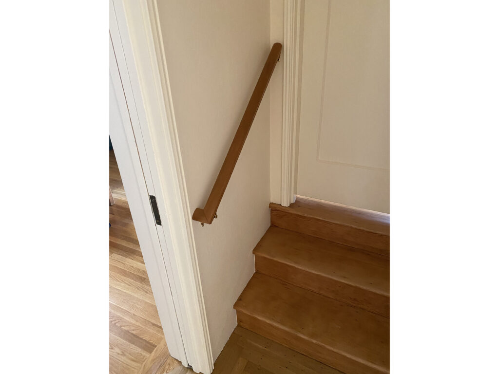 A handrail installed for safety at a staircase in a house