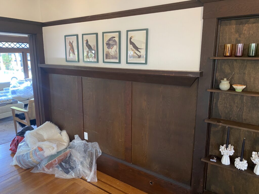 An array of four prints on a dining room wall