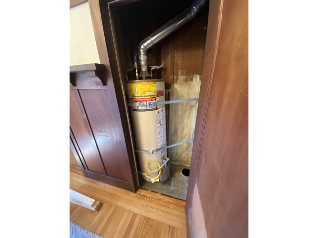 A water heater strapped to the wall for safety