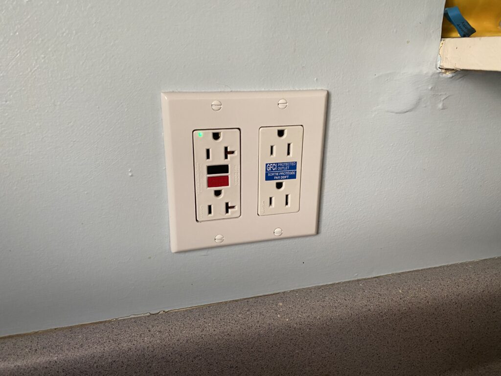 A GFCI outlet and a protected outlet next to it