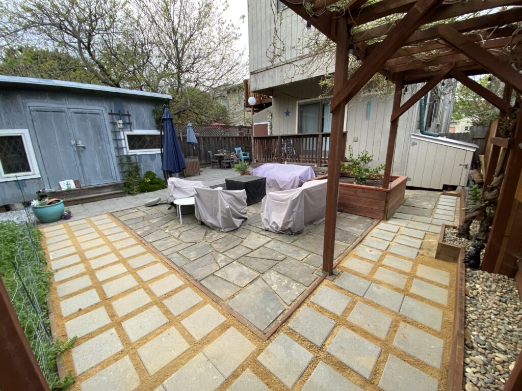 Square pavers installed in a grid pattern with decomposed granite in the gaps between them